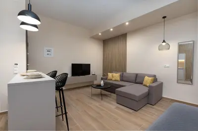 a living room with a couch and a tv at Elegant Studio Apartment in Athens in Athens