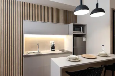 a kitchen with a sink and a table with chairs at Elegant Studio Apartment in Athens in Athens