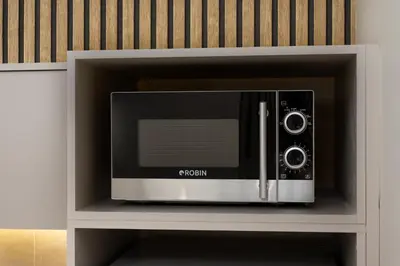 a microwave oven sitting inside of a cabinet at Elegant Studio Apartment in Athens in Athens