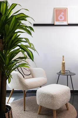 a living room with a chair and a table at Glyfada First Class Suite by First Class Properties in Athens