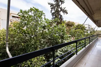 a balcony of a building with a tree at Glyfada First Class Suite by First Class Properties in Athens