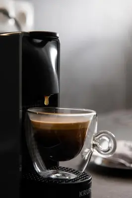 a coffee maker is making a cup of coffee at Glyfada First Class Suite by First Class Properties in Athens