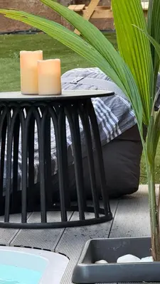 a table with two candles on it next to a pool at Ablaze Luxury Athens in Glyka Nera