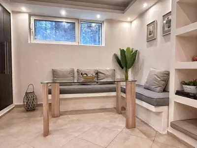 a living room with a table and a window at Ablaze Luxury Athens in Glyka Nera