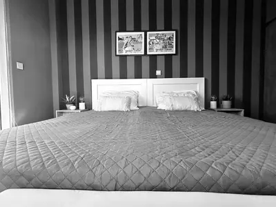a black and white bedroom with a large bed at Ablaze Luxury Athens in Glyka Nera
