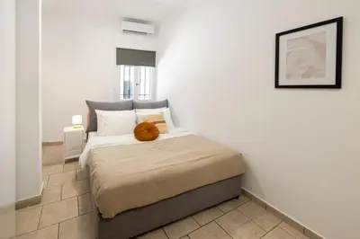 a bedroom with a bed with a stuffed animal on it at Phaedrus Living Athens City Studios Paris in Athens