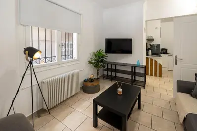 a living room with a couch and a table at Phaedrus Living Athens City Studios Paris in Athens