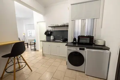 a kitchen with a washing machine and a microwave at Phaedrus Living Athens City Studios Paris in Athens