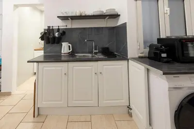 a kitchen with a sink and a microwave at Phaedrus Living Athens City Studios Paris in Athens