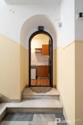 an archway leading into a room with a staircase at Vea Studio Plaka in Athens