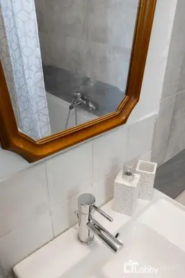 a bathroom with a sink with a mirror above it at Vea Studio Plaka in Athens
