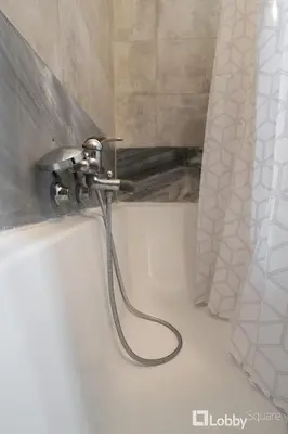 a shower hose is attached to the wall of a bathroom at Vea Studio Plaka in Athens