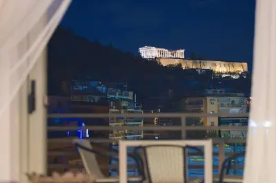 a view of a building from a window at night at Acropolis Landscape in Athens