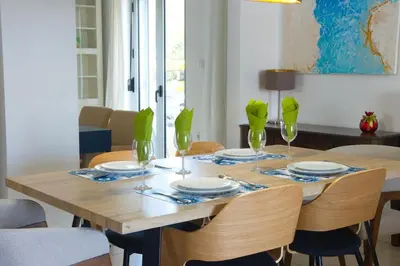 a dining room table with plates and wine glasses at Acropolis Landscape in Athens