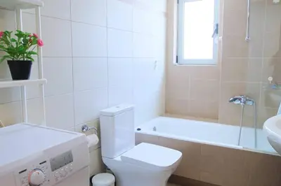 a bathroom with a toilet and a sink and a tub at Acropolis Landscape in Athens