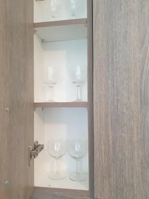 a glass cabinet with wine glasses in it at Lavender-Ryan spacious apartment for live and work in heart of Athens in Athens