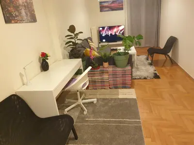 a living room with a desk and potted plants at Lavender-Ryan spacious apartment for live and work in heart of Athens in Athens