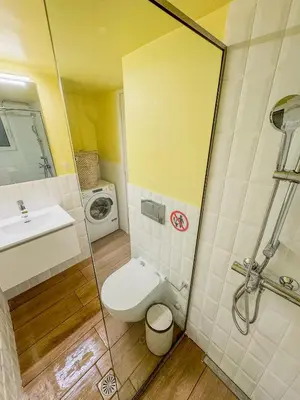 a bathroom with a toilet and a sink and a shower at Ανακαινισμένο σπίτι με ιδιωτική αυλή in Piraeus