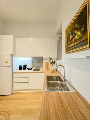 a kitchen with a sink and a counter top at Ανακαινισμένο σπίτι με ιδιωτική αυλή in Piraeus
