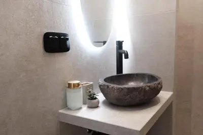 a bathroom with a bowl sink on a counter at Unique 2BD Design Apt with airconditioning near Acropolis in Athens