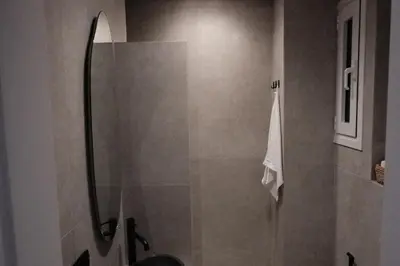 a shower with a glass door in a bathroom at Unique 2BD Design Apt with airconditioning near Acropolis in Athens