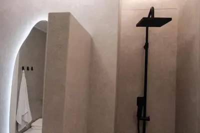 a cross on a wall next to a shower at Unique 2BD Design Apt with airconditioning near Acropolis in Athens