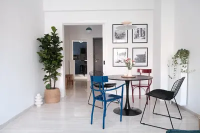 a dining room with a table and chairs at Unique 2BD Design Apt with airconditioning near Acropolis in Athens