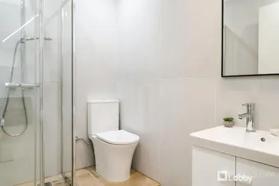 a white bathroom with a toilet and a sink at CityLiv Concept in Athens