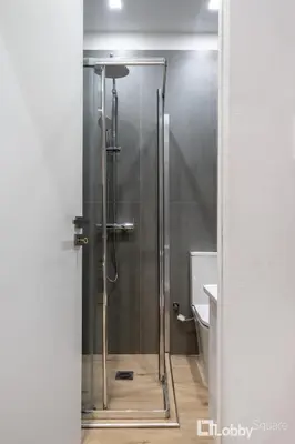 a shower with a glass door in a bathroom at CityLiv Concept in Athens