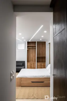 a bedroom with a bed and a wooden closet at CityLiv Concept in Athens