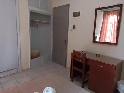 a bathroom with a sink and a desk and a mirror at Elite Hotel in Athens