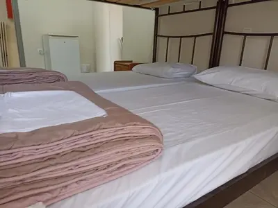 two beds sitting next to each other in a bedroom at Elite Hotel in Athens