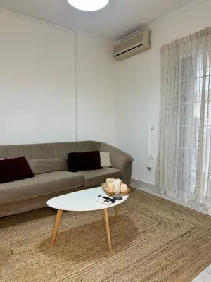 a living room with a couch and a coffee table at Urban lodge Agios Dimitrios in Athens