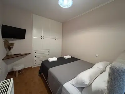 a bedroom with a bed and a television in it at Urban lodge Agios Dimitrios in Athens