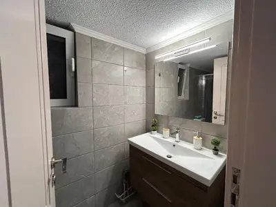 a bathroom with a sink and a mirror at Urban lodge Agios Dimitrios in Athens