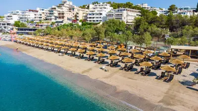 an overhead view of a beach with chairs and umbrellas at Vouliagmeni Seaside Escape in Athens