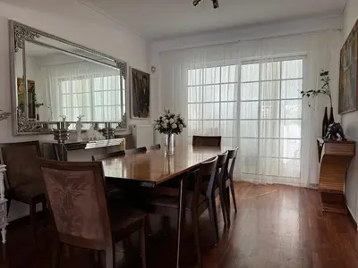 a dining room with a table and a mirror at Vouliagmeni Seaside Escape in Athens