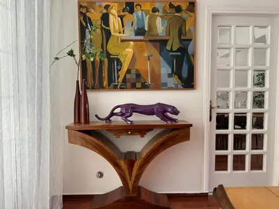 a cat statue on a table in a room with a painting at Vouliagmeni Seaside Escape in Athens