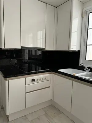 a kitchen with white cabinets and a sink at Vouliagmeni Seaside Escape in Athens