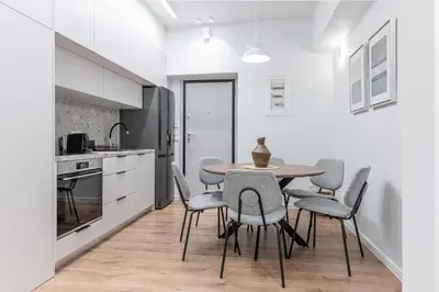a dining room with a table and chairs in a kitchen at Phaedrus Living Prosperity Residences Paradise in Athens