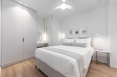 a white bedroom with a white bed and a white closet at Phaedrus Living Prosperity Residences Paradise in Athens