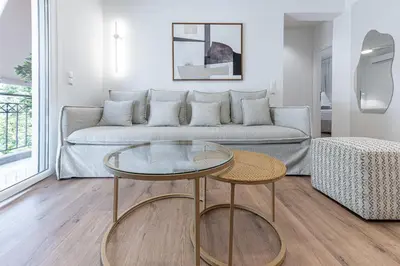 a living room with a couch and a glass table at Phaedrus Living Prosperity Residences Paradise in Athens