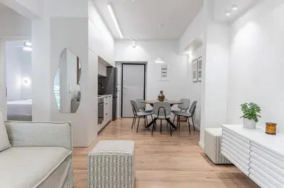 a white living room with a table and chairs at Phaedrus Living Prosperity Residences Paradise in Athens