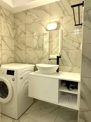 a white bathroom with a washing machine and a sink at Walk into Dream of Acropolis 11 in Athens