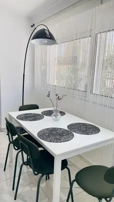 a white table with green chairs and a lamp at Walk into Dream of Acropolis 11 in Athens