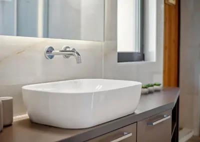 a bathroom with a white sink and a mirror at Penthouse Sauna & Jacuzzi in Glyfada in Athens