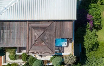 an overhead view of a wooden building with a swimming pool at Penthouse Sauna & Jacuzzi in Glyfada in Athens