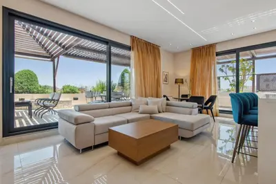 a living room with a couch and a table at Penthouse Sauna & Jacuzzi in Glyfada in Athens