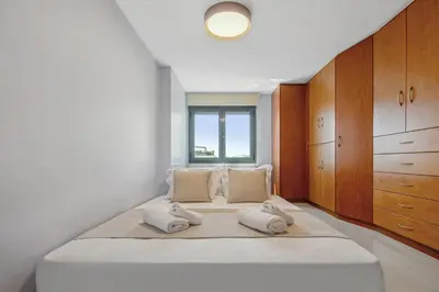 a bedroom with a large bed with two pillows at Penthouse Sauna & Jacuzzi in Glyfada in Athens