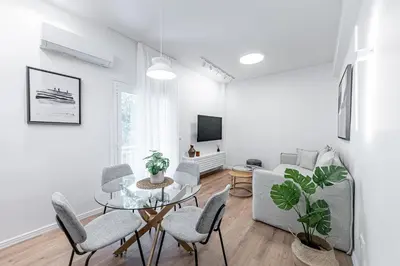 a living room with a table and chairs and a couch at Phaedrus Living Prosperity Residences Harmony in Athens